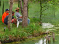 Family fishing on one of the lakes at Twin Lakes caravanpark in France